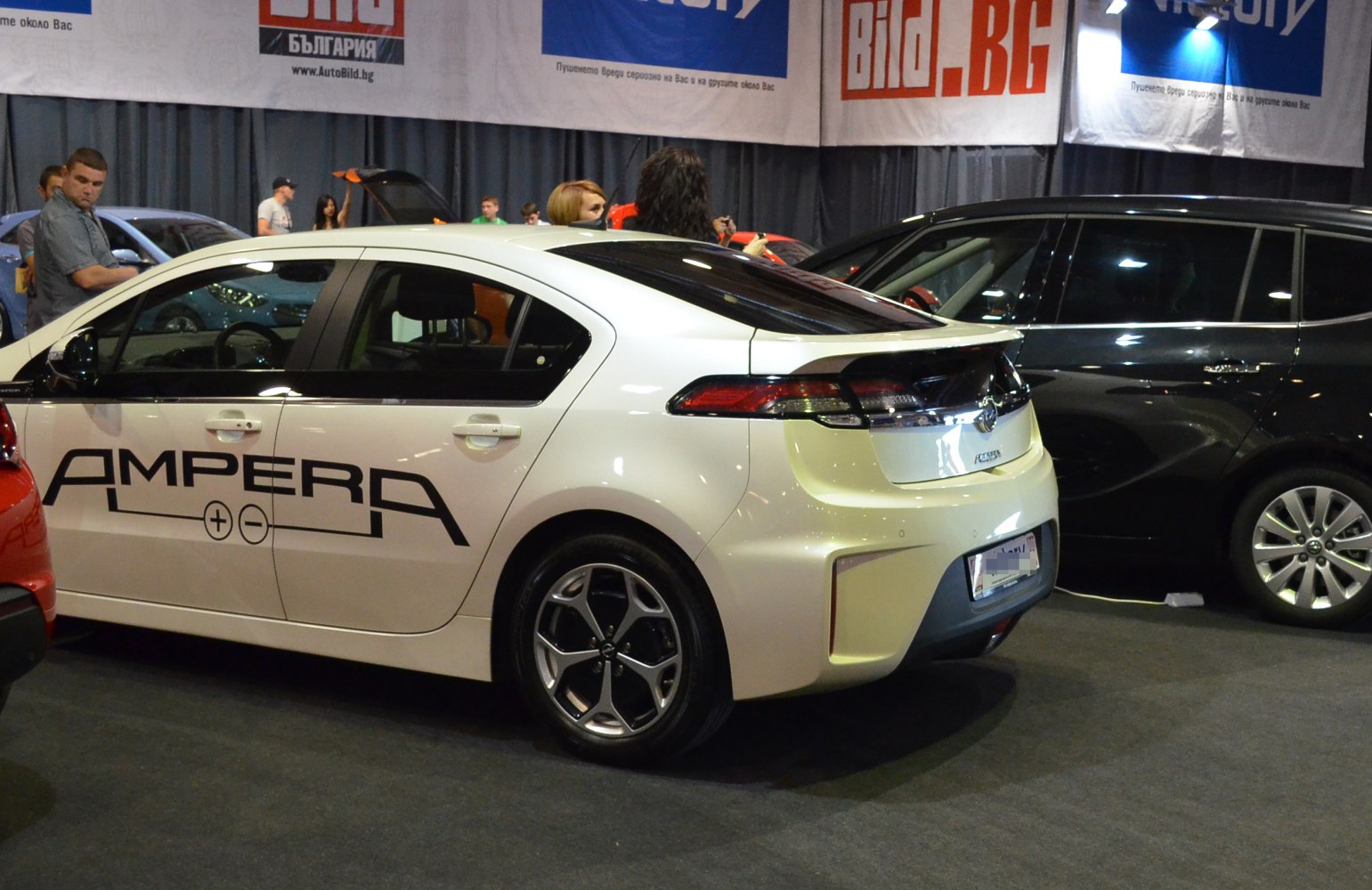 Rear side view of hatchback with distinct decal and alloy wheels