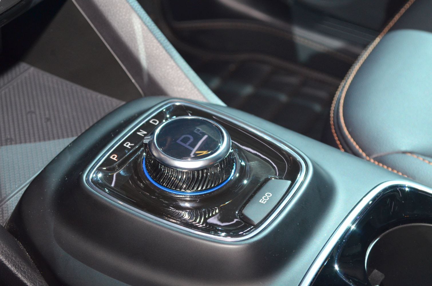 Rotary gear selector knob and ECO mode button with modern car interior accents