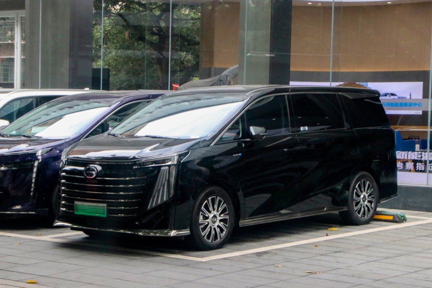 Black luxury minivan with vertical LED headlights and multi-section front grille