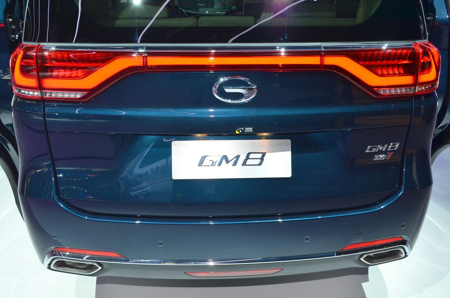 Rear LED tail light with integrated chrome trim and dual exhaust outlets