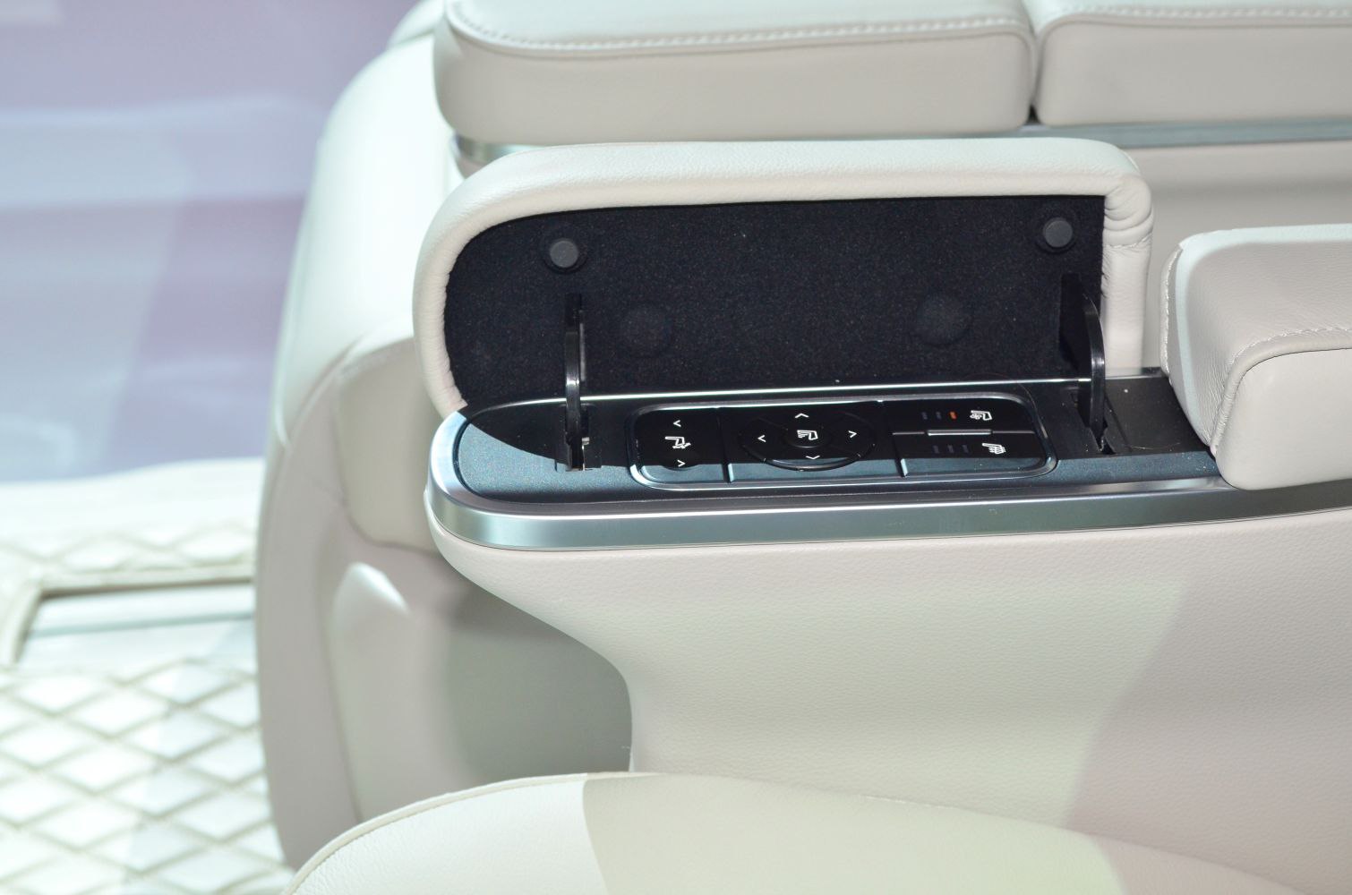 Armrest control panel with seat adjustment and heating controls.