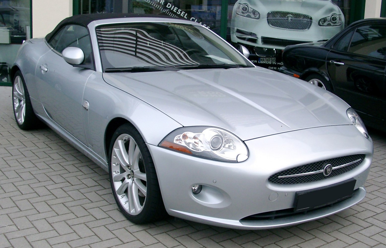 Jaguar XK convertible front and side view, silver body, alloy wheels