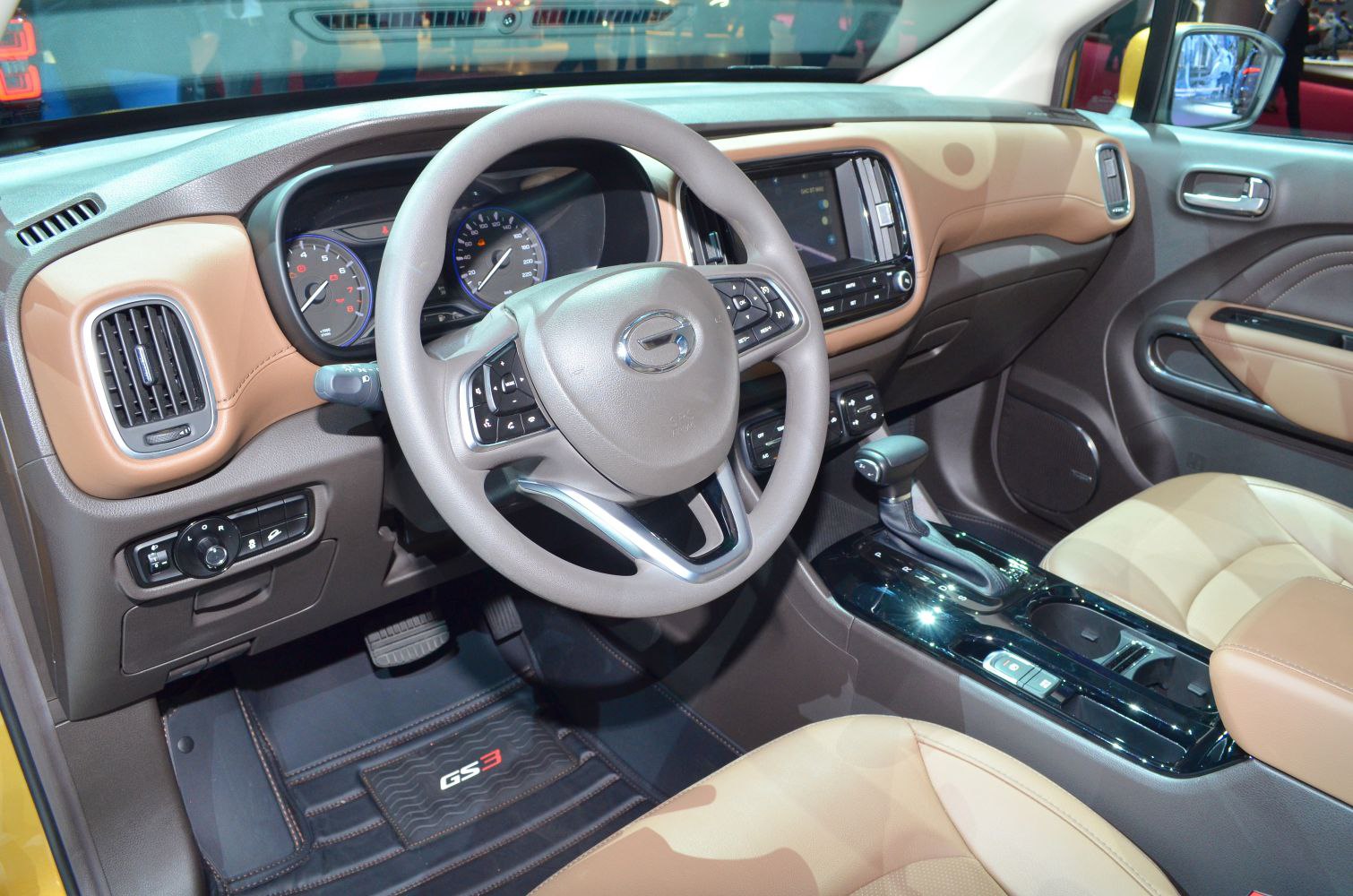 Multifunction steering wheel and modern dashboard with infotainment screen.