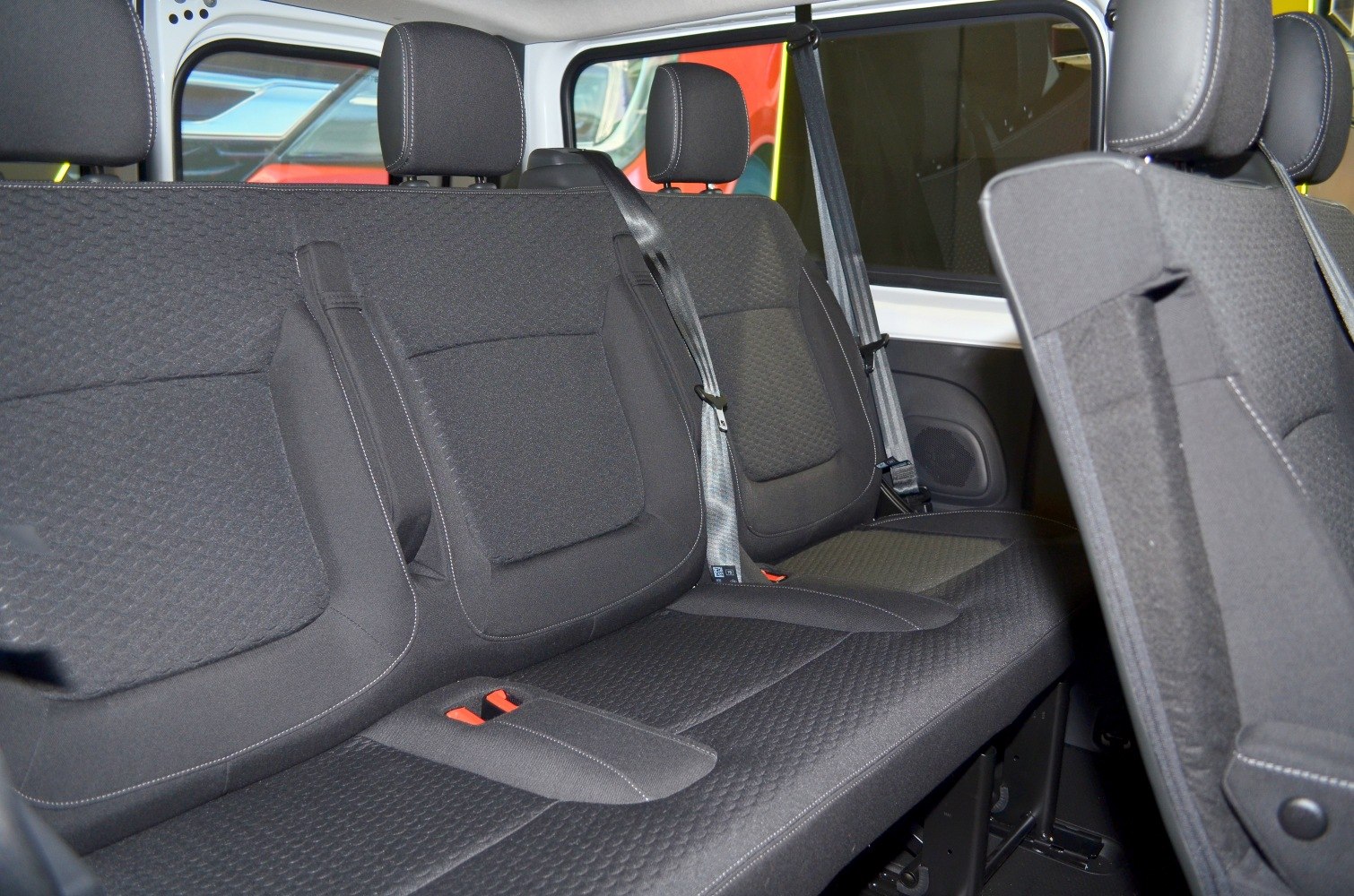 Rear passenger seats with fabric upholstery and integrated headrests