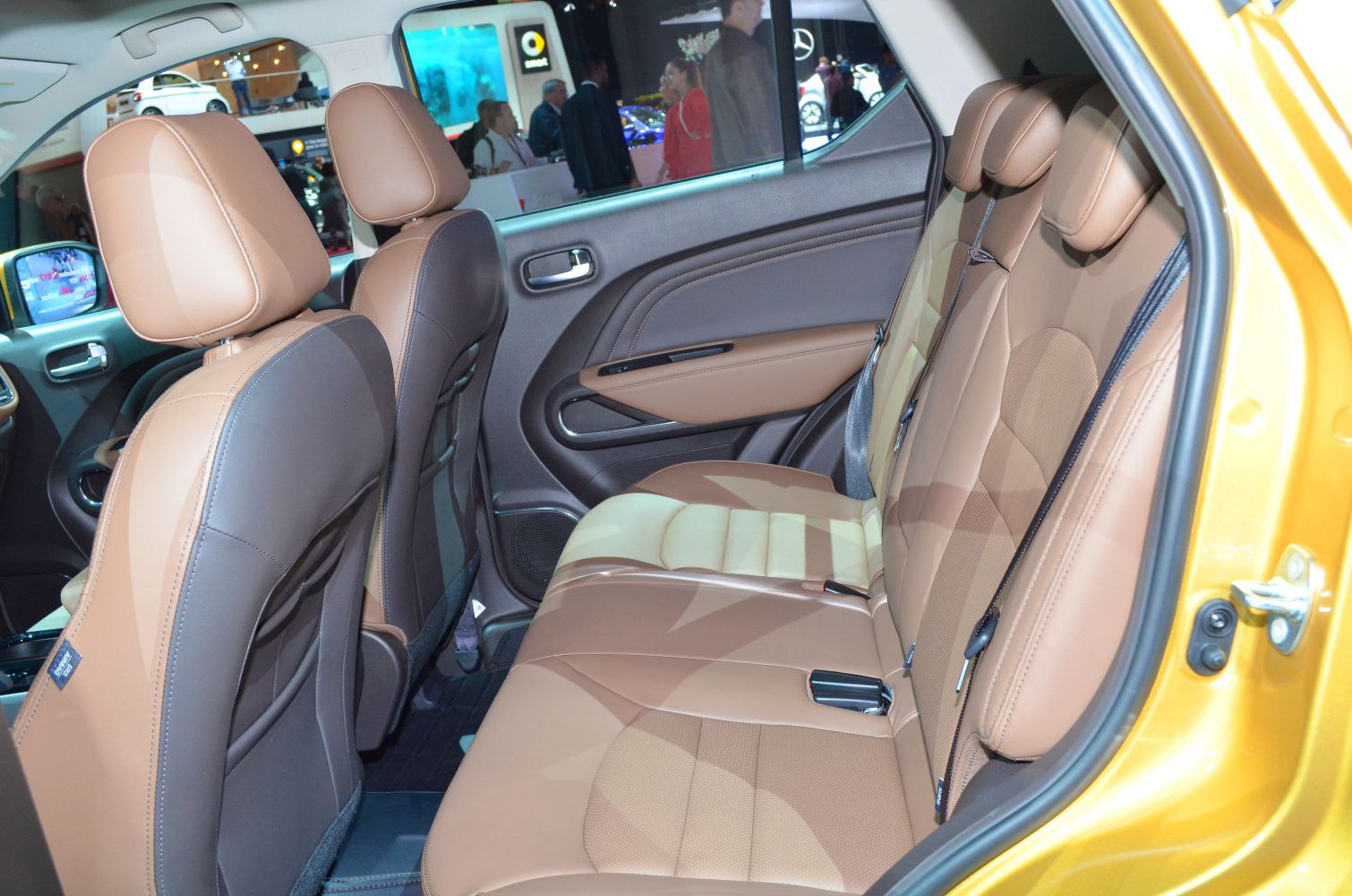 Rear seat interior with brown leather upholstery and door panel design