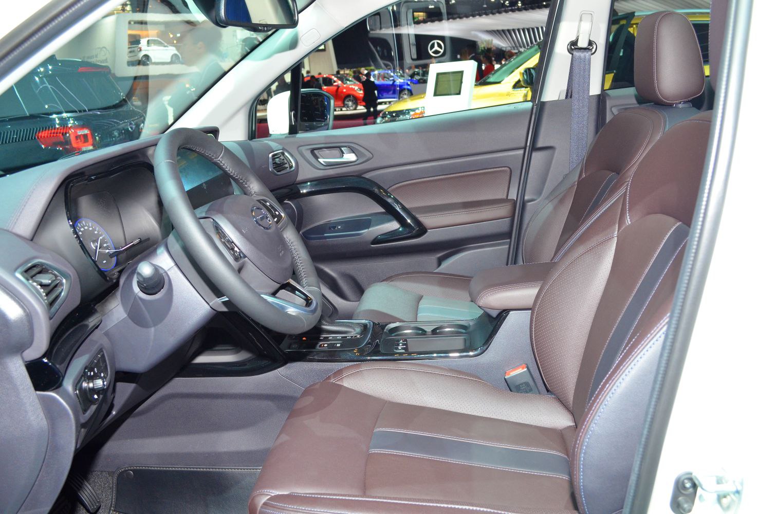 Brown leather seats and modern dashboard with steering wheel and center console