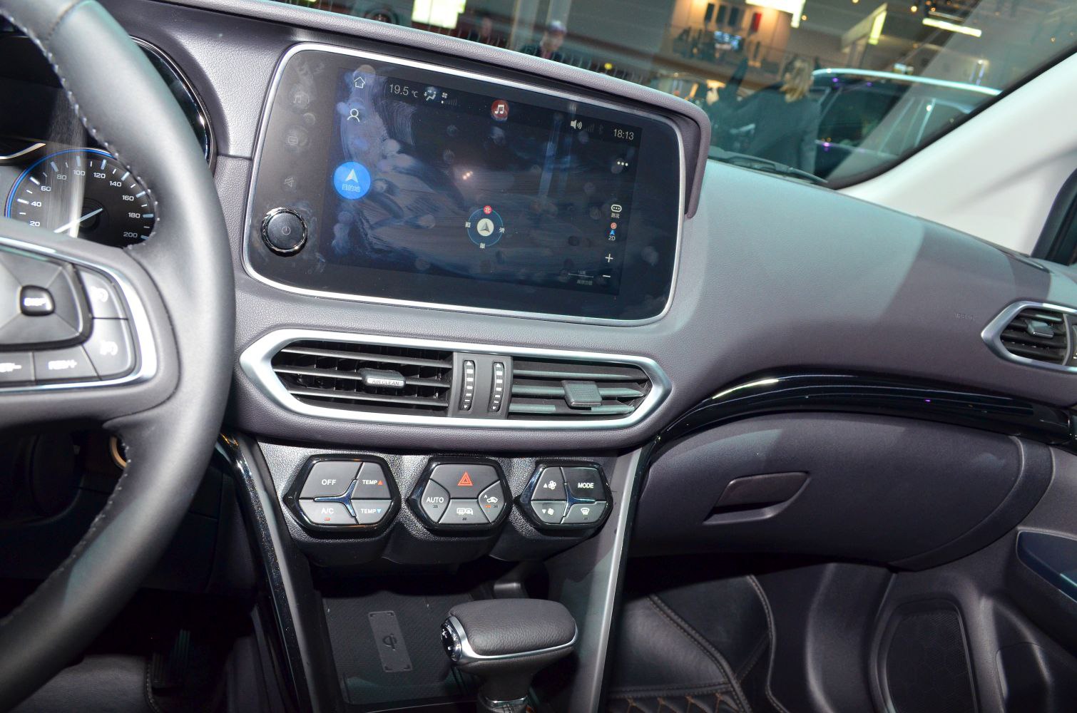 Touchscreen infotainment and climate control buttons in car dashboard