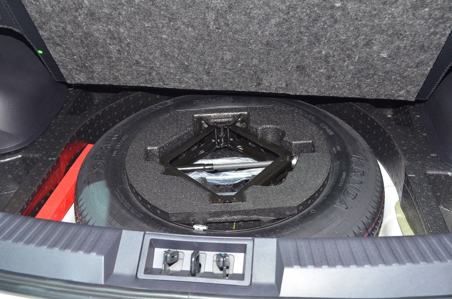 Spare tire with jack kit in trunk compartment
