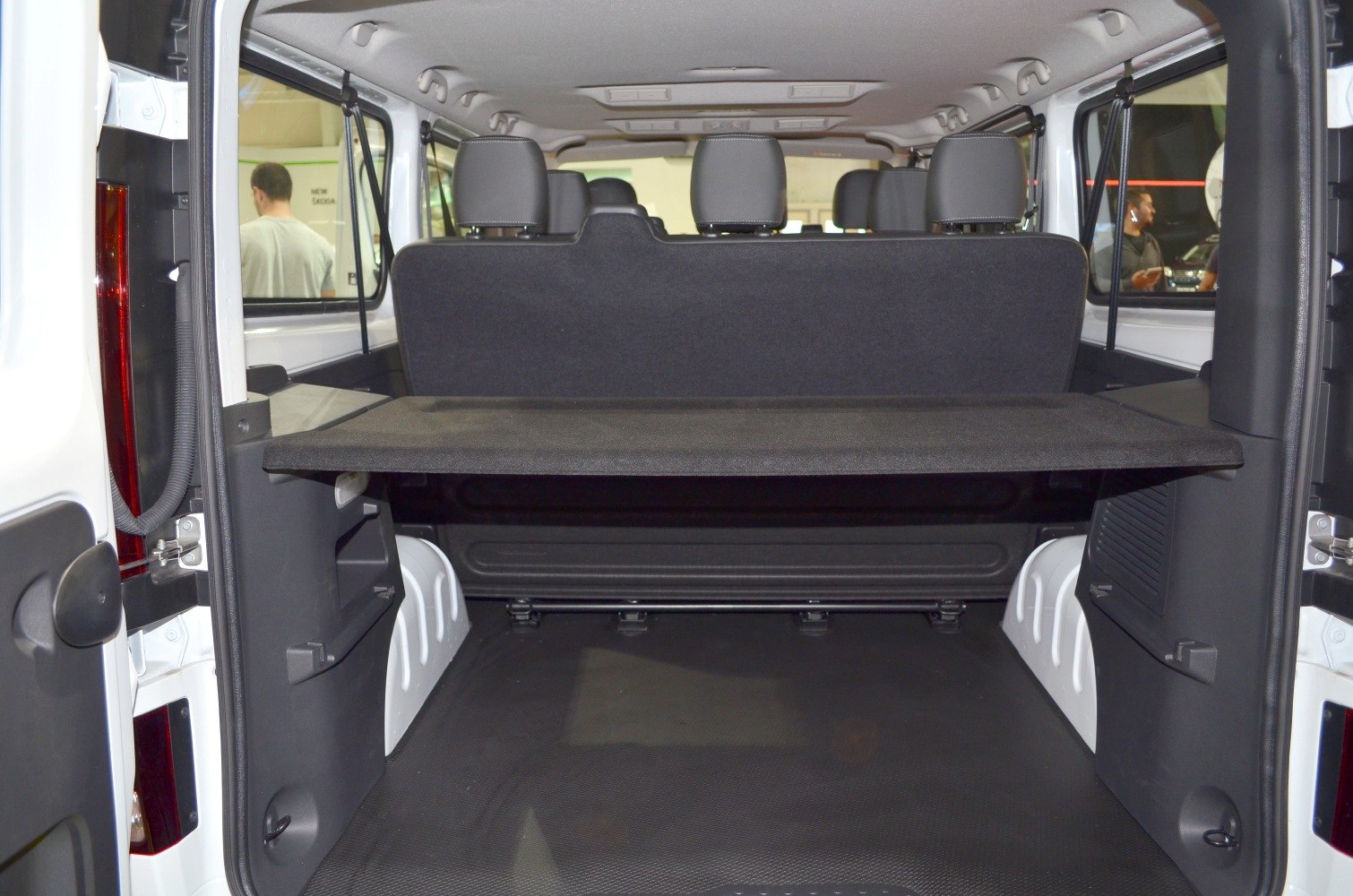 Spacious rear cargo compartment with foldable rear seats in a van interior.
