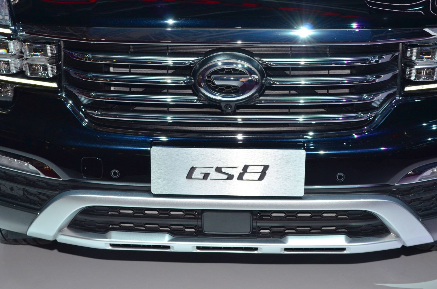 Close-up of front grille and badge with modern LED headlights