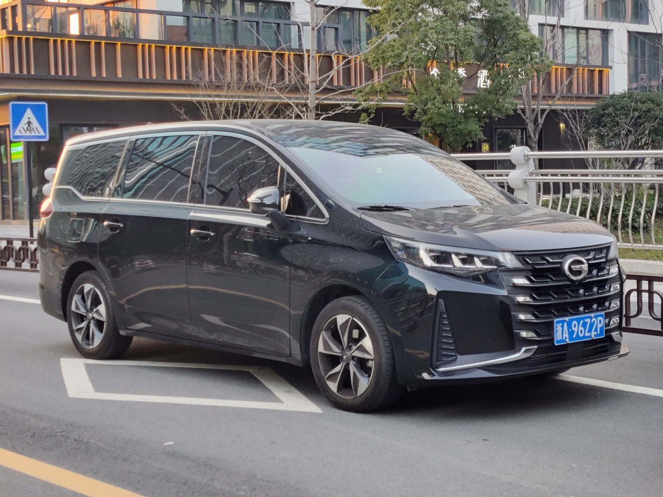Bold chrome-accented front grille and sharp LED headlights on a modern MPV