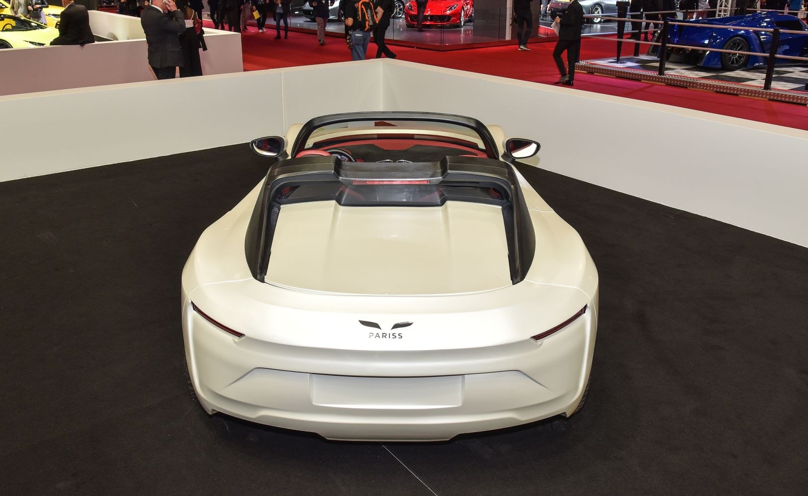 Rear view of a sleek convertible electric sports car with aerodynamic design.