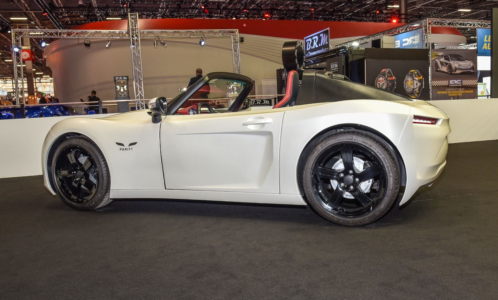 White electric roadster with black alloy wheels and convertible design