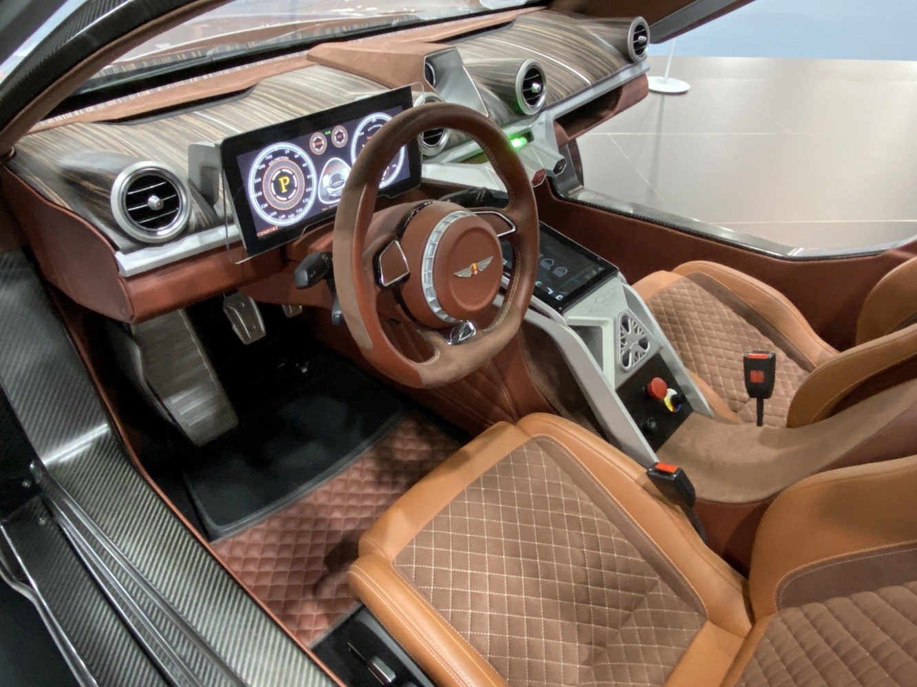 Brown leather seats with diamond stitching and digital dashboard display