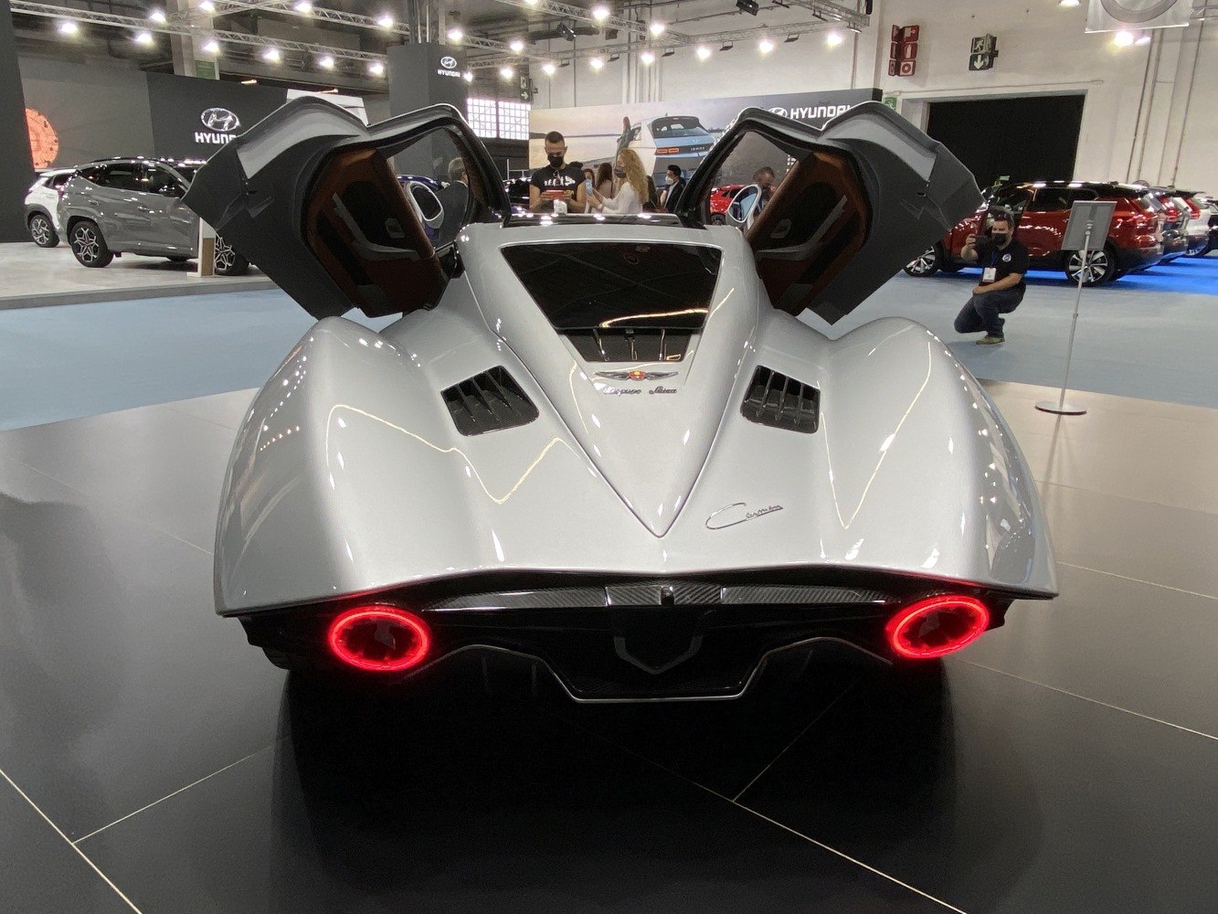 Rear view with butterfly doors open and circular illuminated tail lights