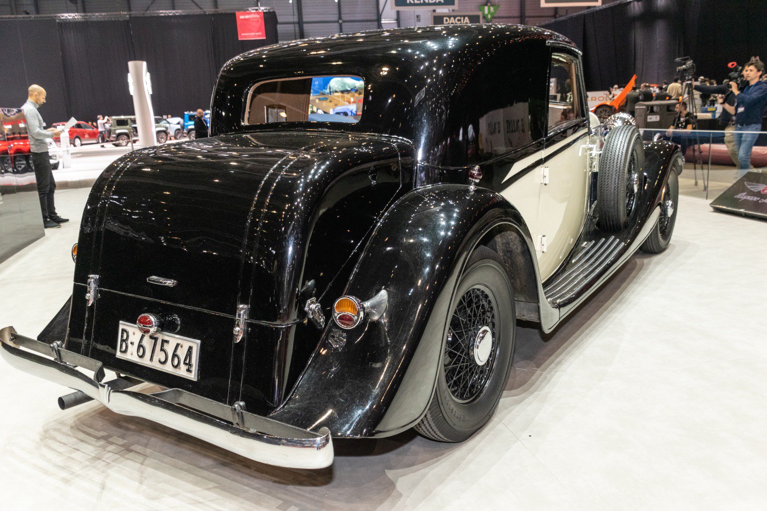 Rear and side view of classic luxury coupe with spoked wheels and spare tire