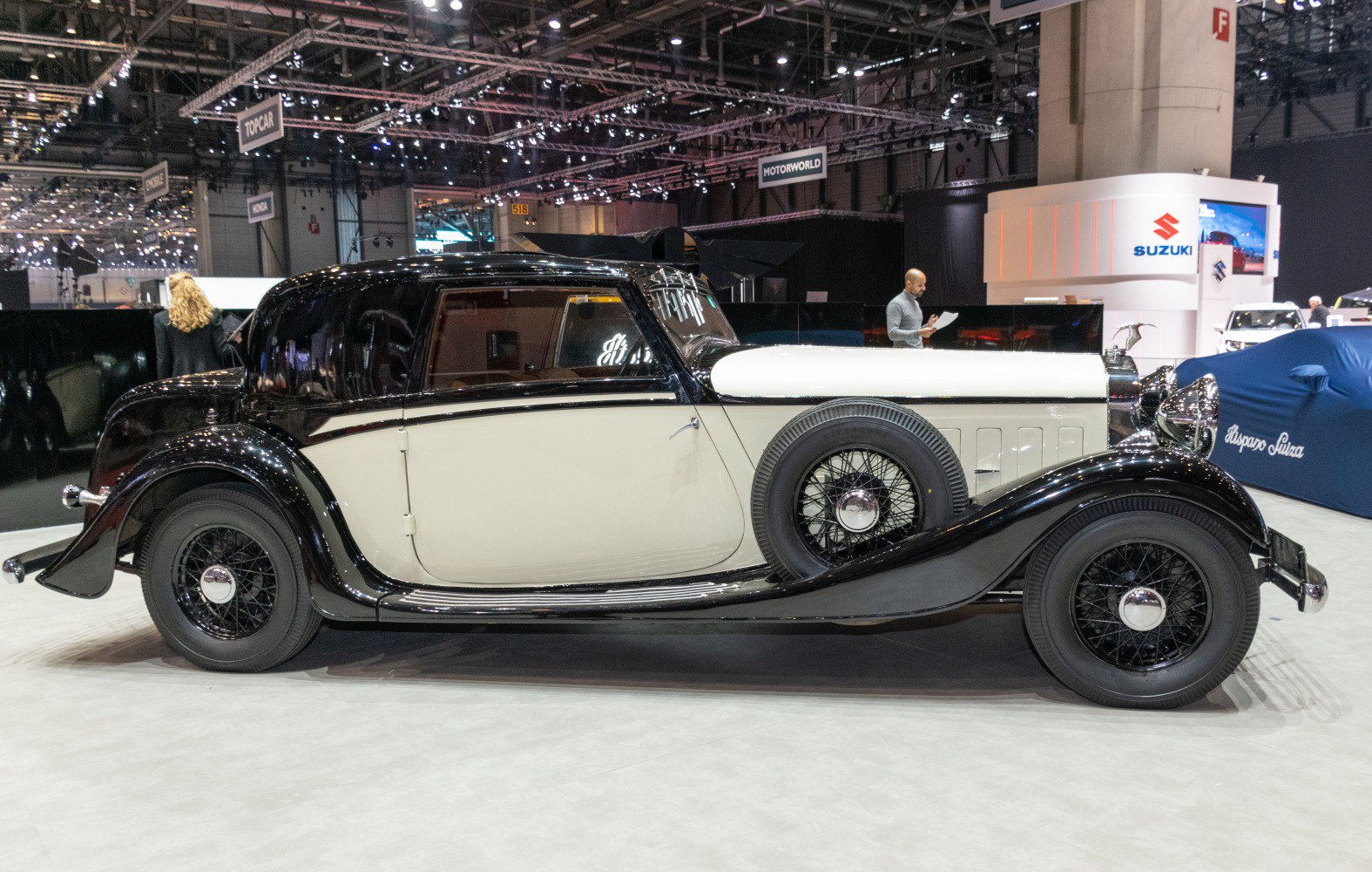 Side-mounted spare wheel and wire wheels on vintage two-tone coupe