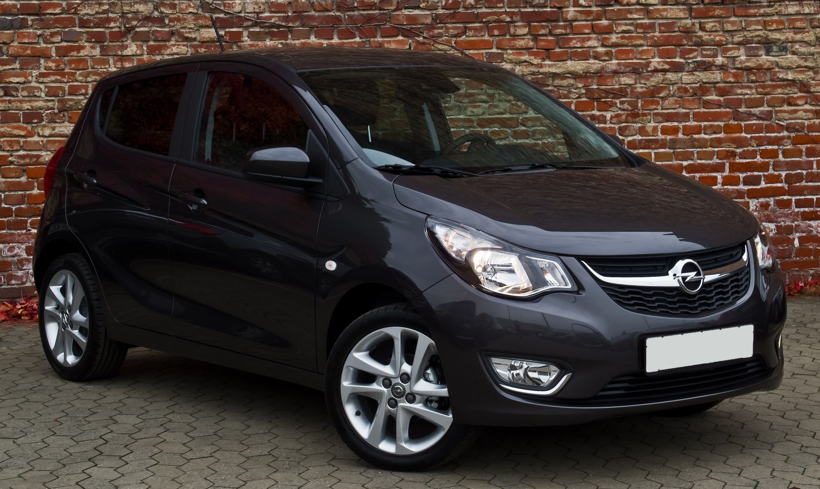 Front angled view of a compact hatchback with alloy wheels.