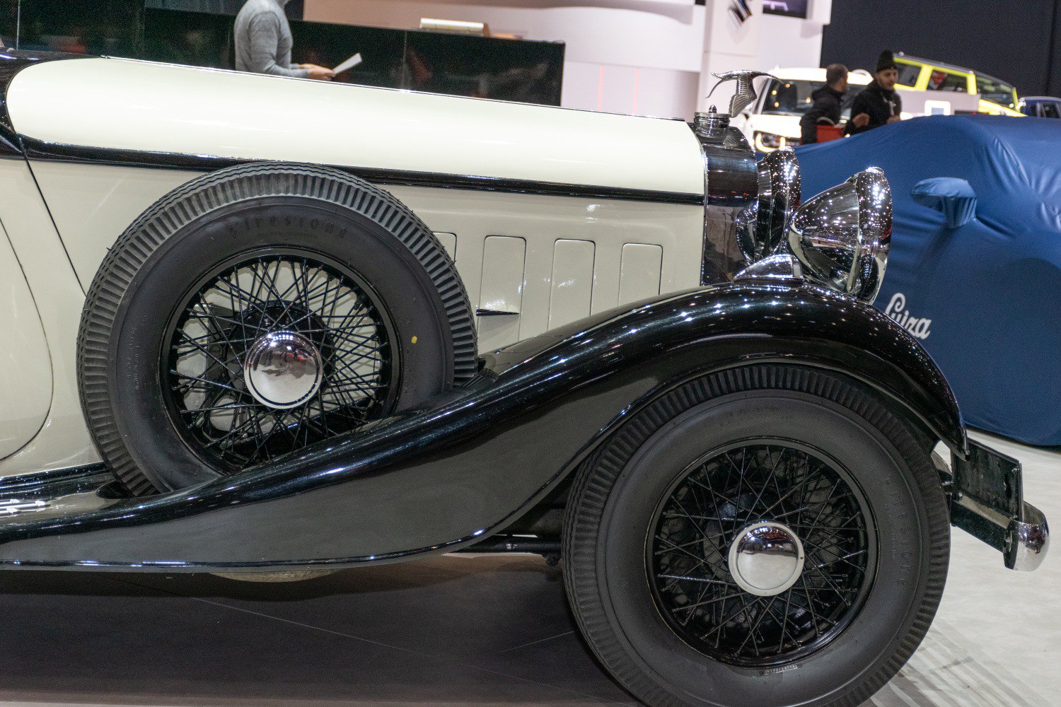 Vintage spoked wheels with chrome hubcaps and glossy curved fender