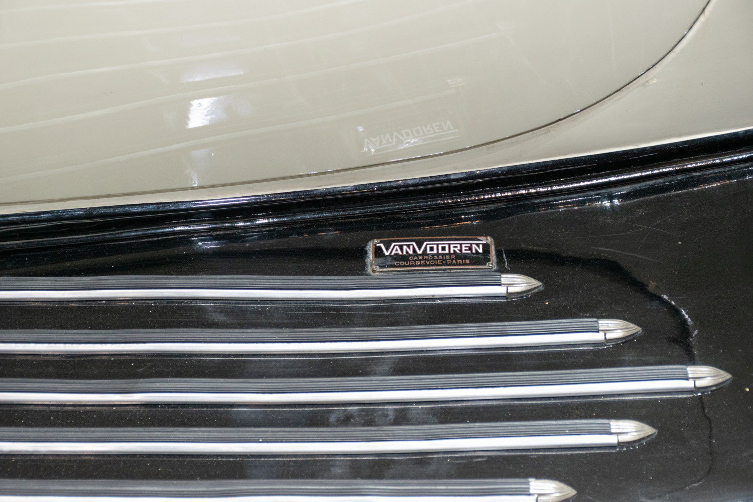 Van Vooren badge and decorative metal strips on vintage car body