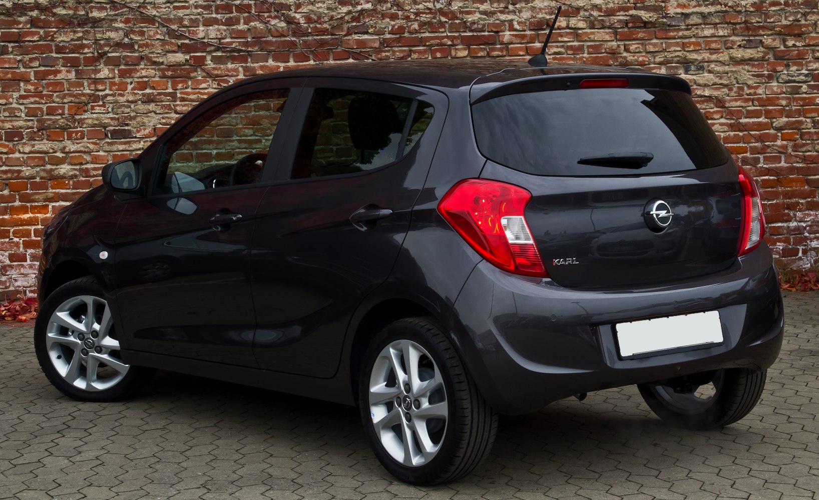 Compact hatchback rear side with alloy wheels and prominent taillights