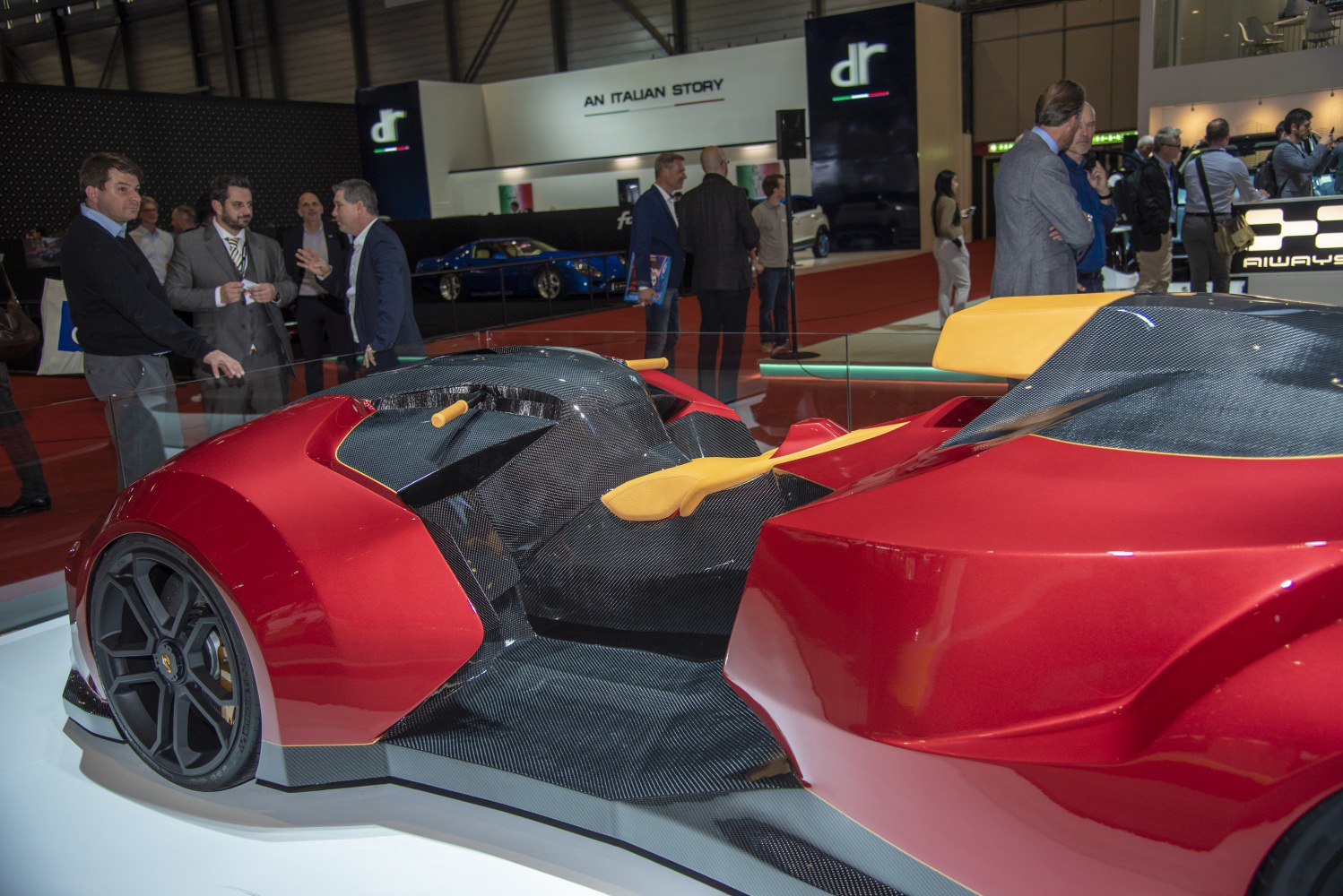 Open-cockpit race vehicle with red carbon fiber body and yellow seats