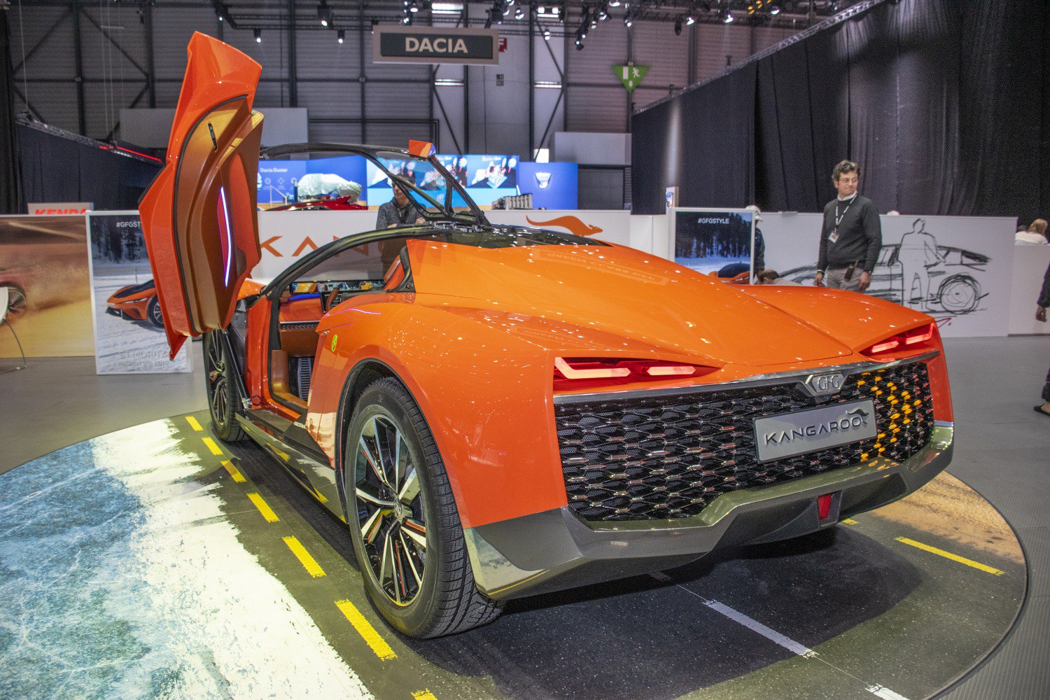 Futuristic orange sports coupe with upward-opening doors.