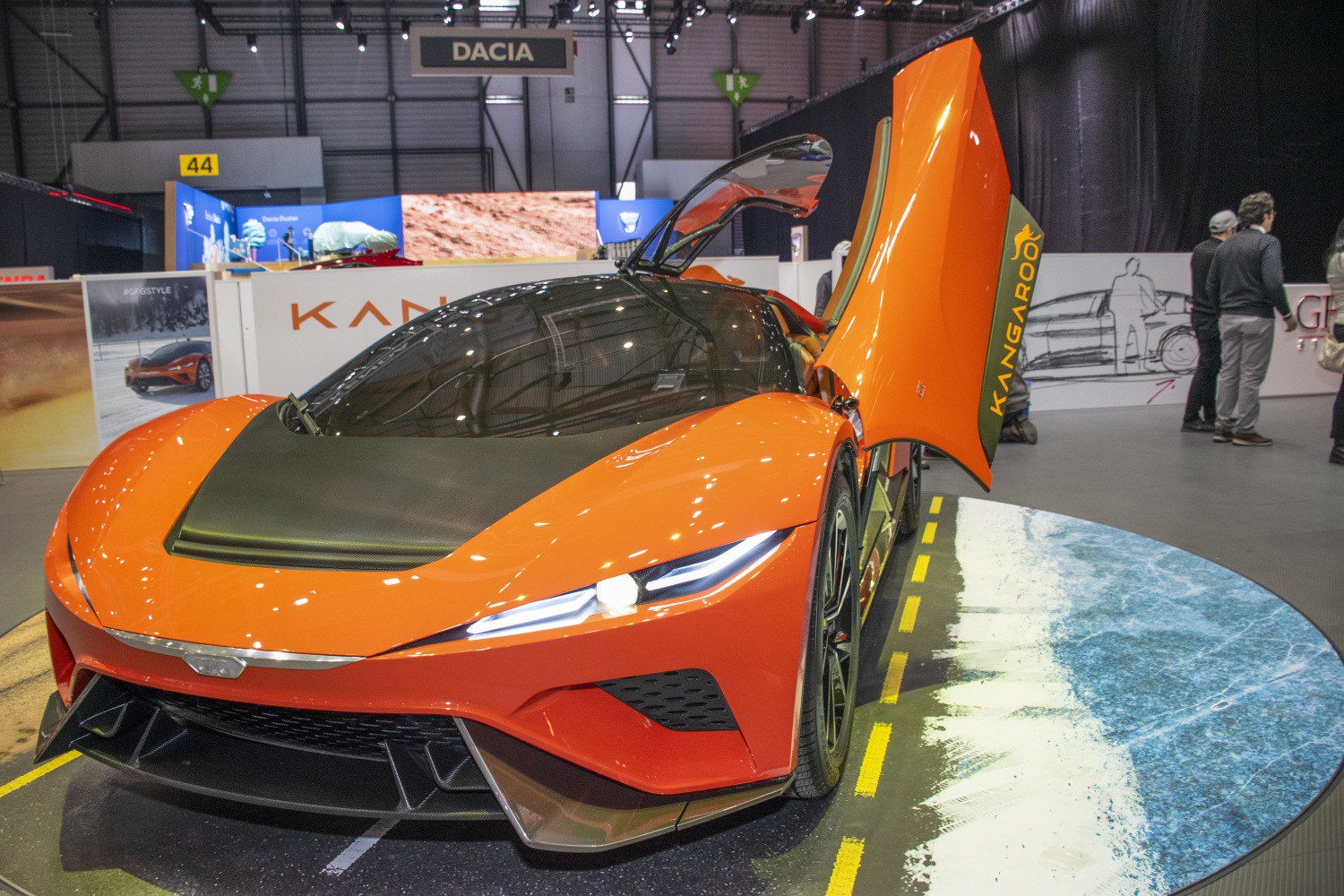 Futuristic orange sports car with butterfly doors.