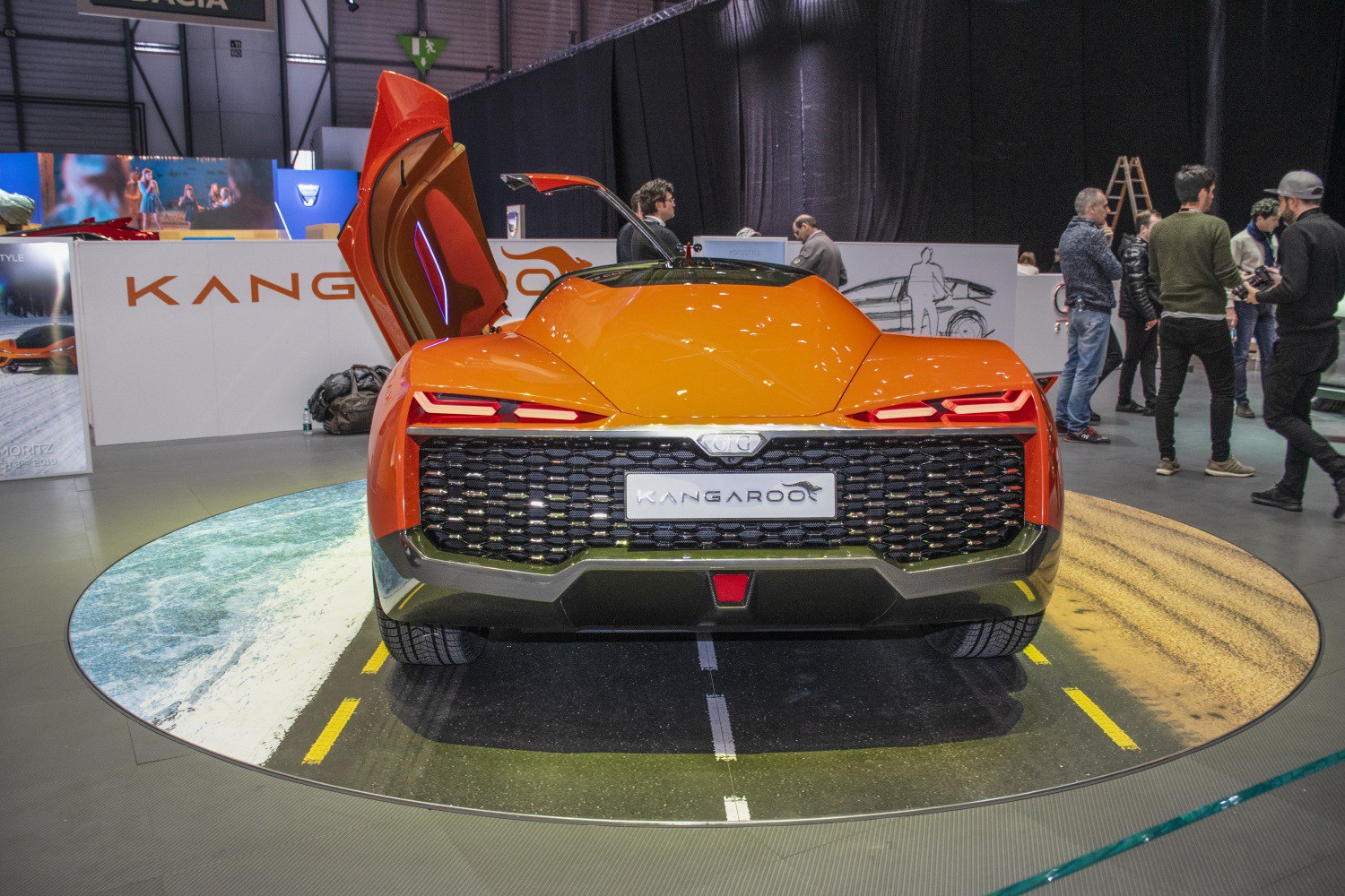Rear view of car with scissor doors and distinctive tail lights.