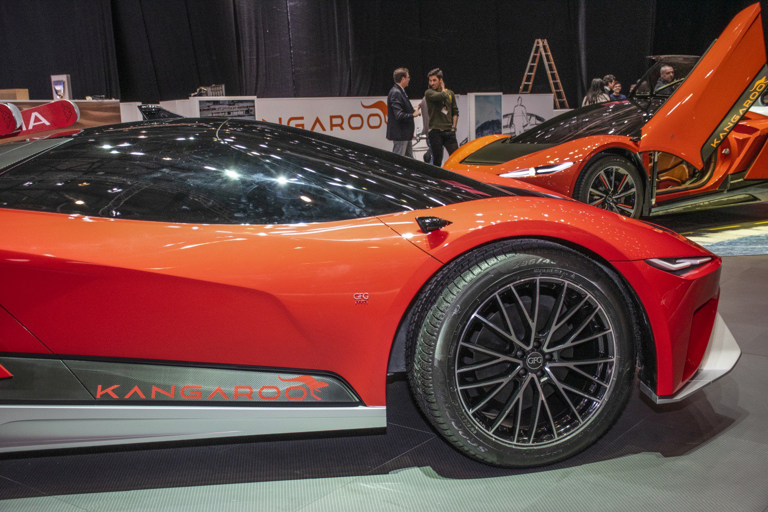 Close-up of front wheel and sleek angular body with orange paint
