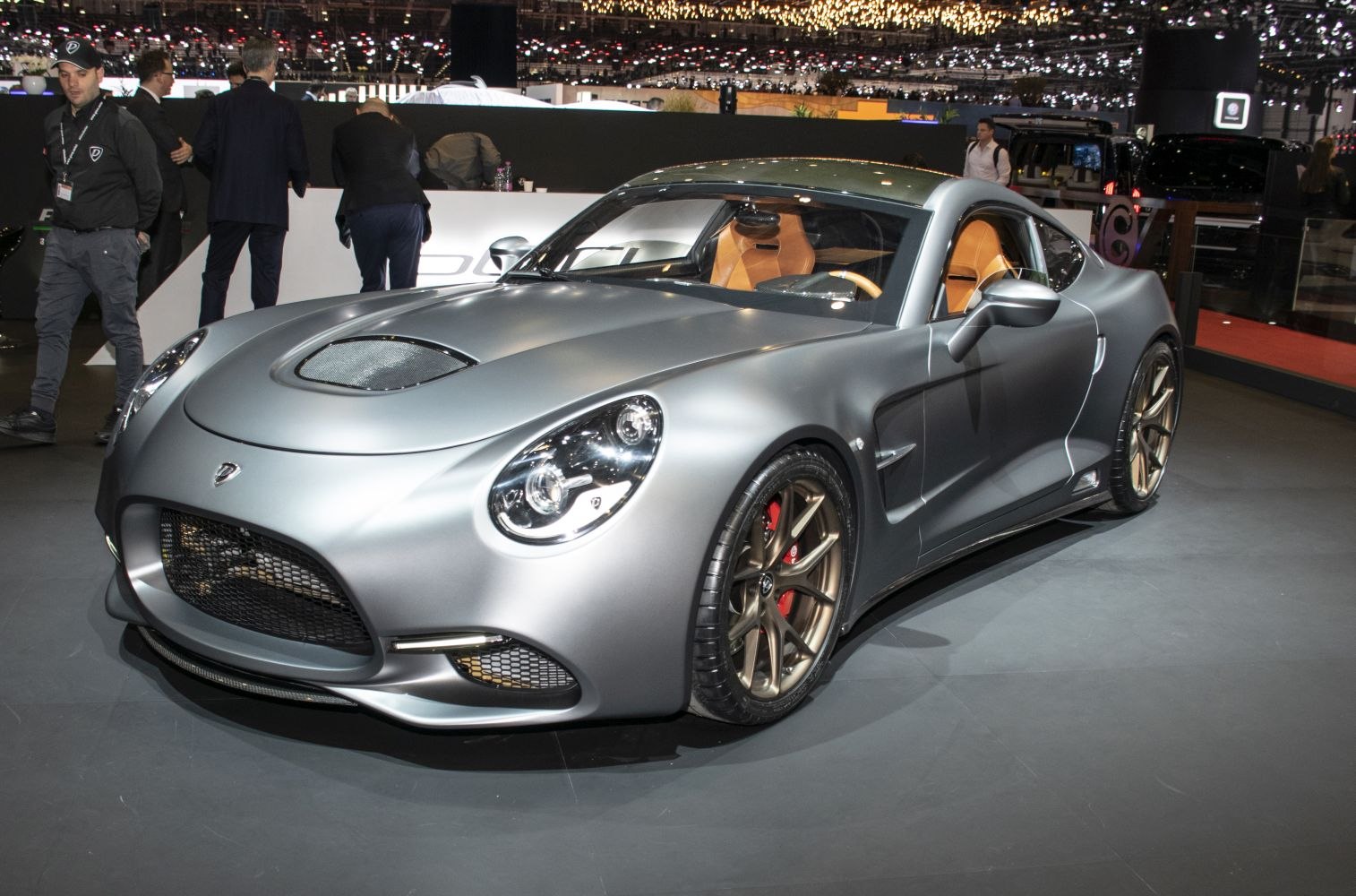 Front view of sleek sports coupe with bronze alloy wheels and aerodynamic design