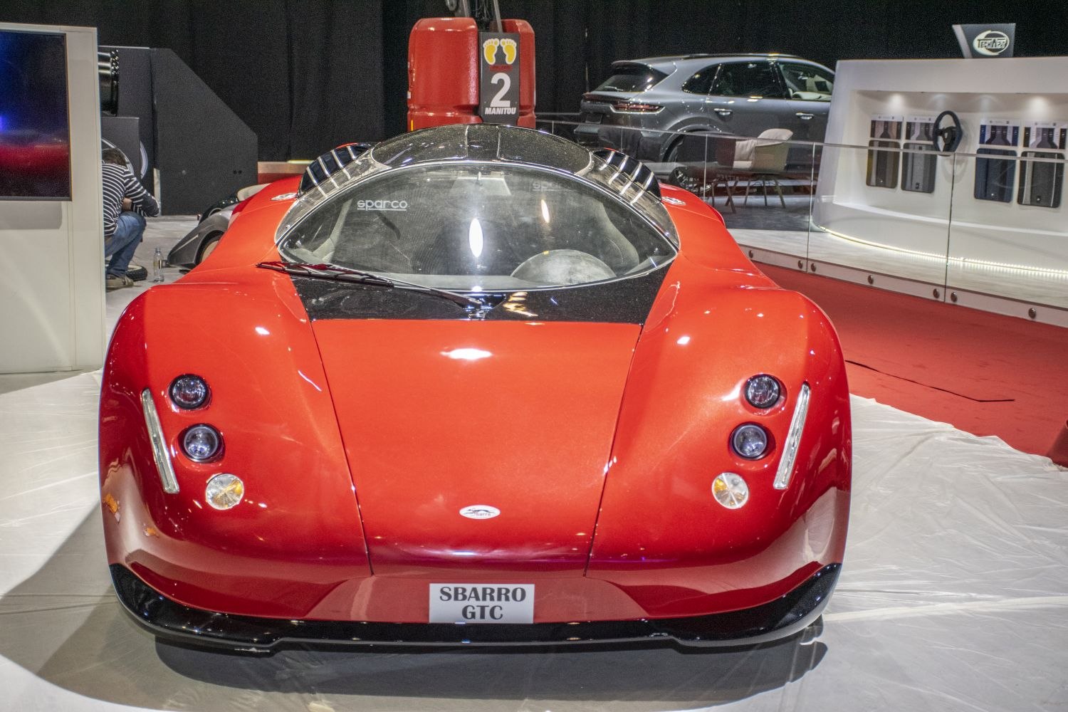 Aerodynamic sports car front with triple headlights and clear windshield