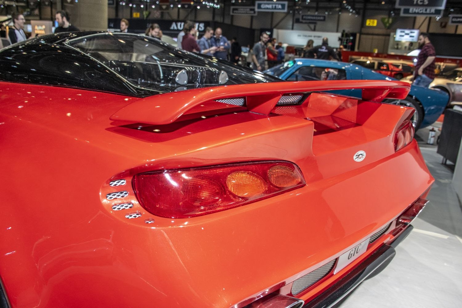 Rear view showcasing spoiler and taillights of a sports car