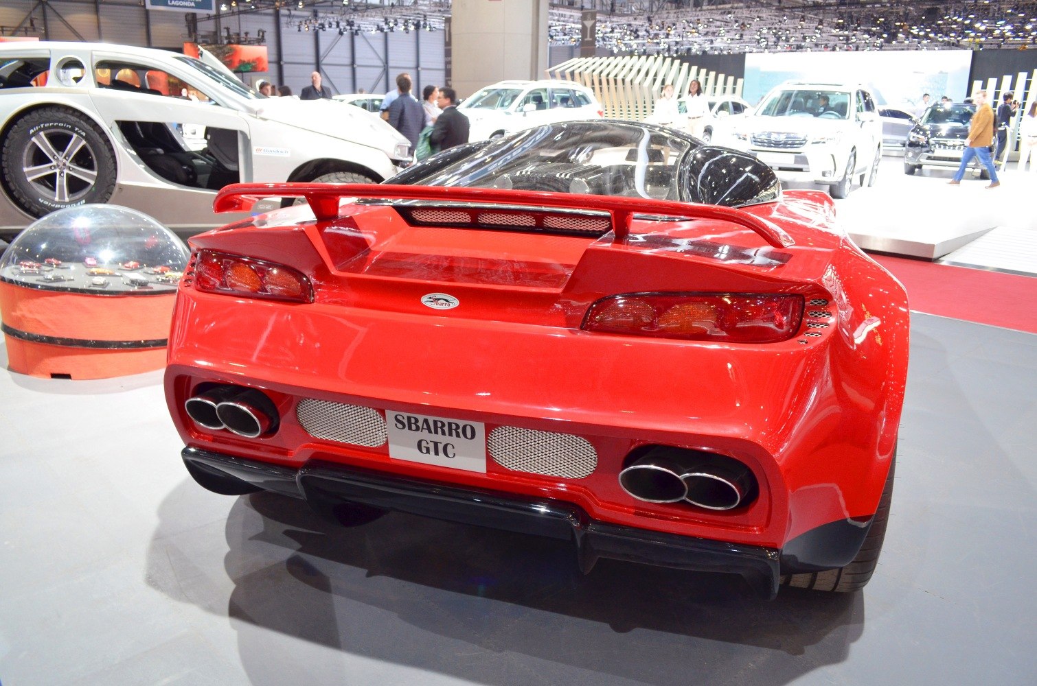 Red sports coupe rear with spoiler and quad exhaust