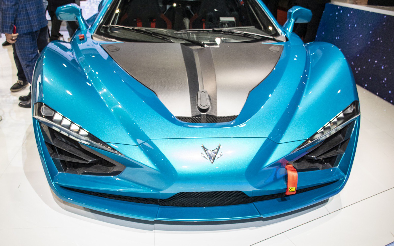 Sharp LED headlights and carbon fiber hood on blue sports car front