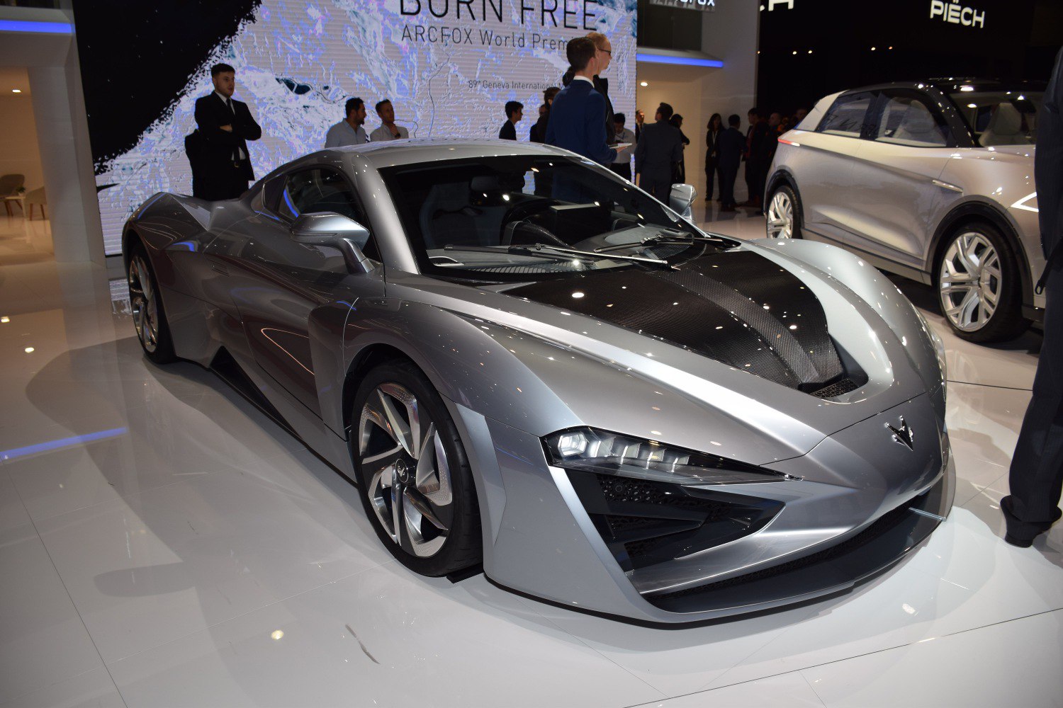 Silver supercar with carbon fiber hood and modern LED headlights