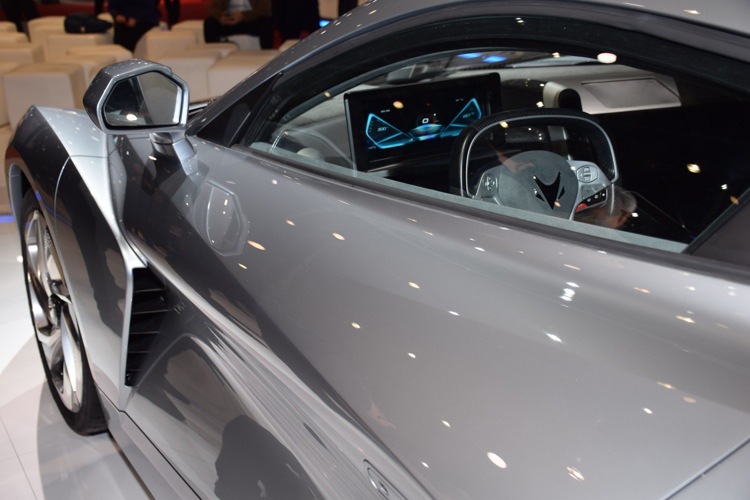 Glossy side profile with digital instrument cluster and futuristic steering wheel
