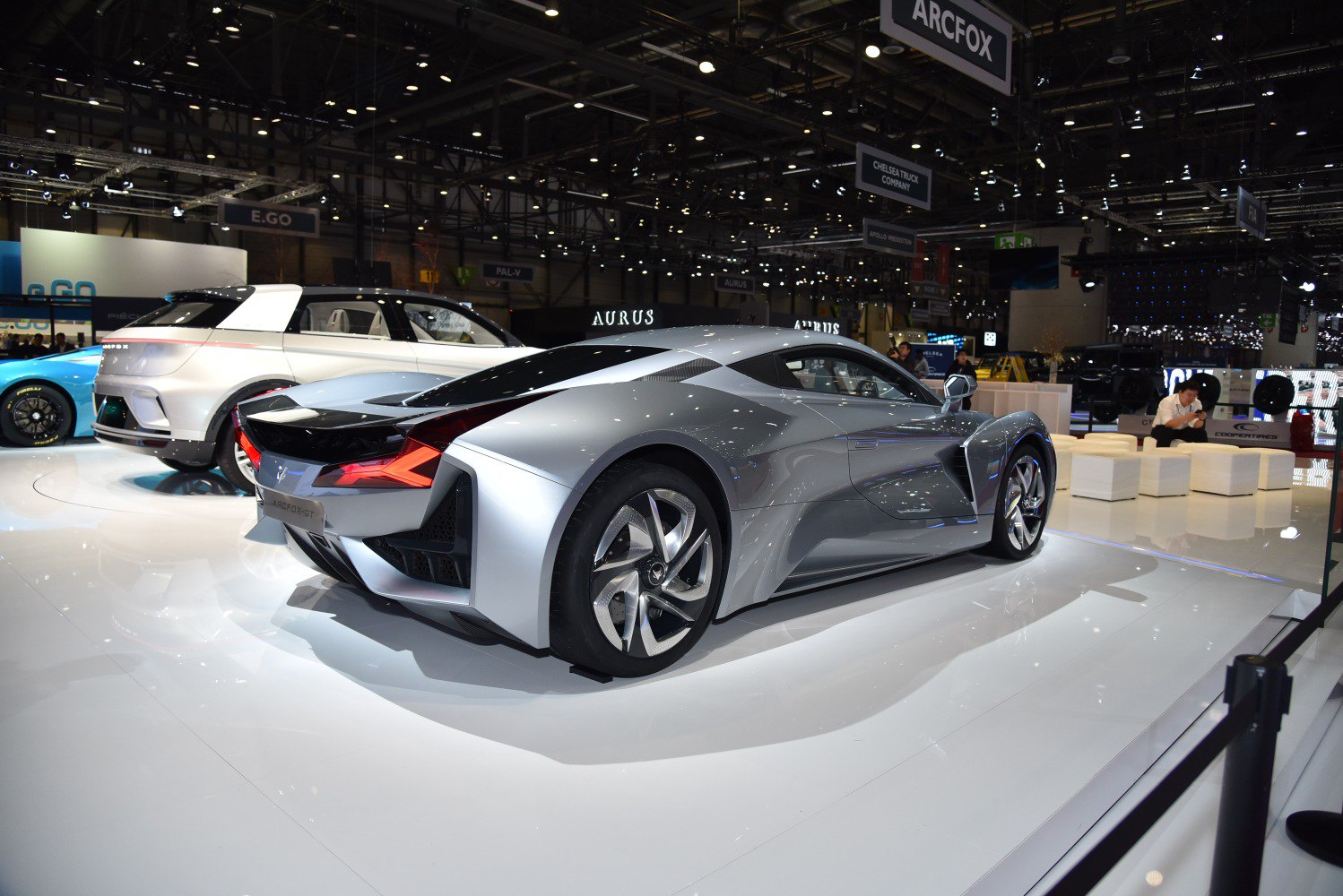 Futuristic silver sports coupe rear and side view with sharp taillights