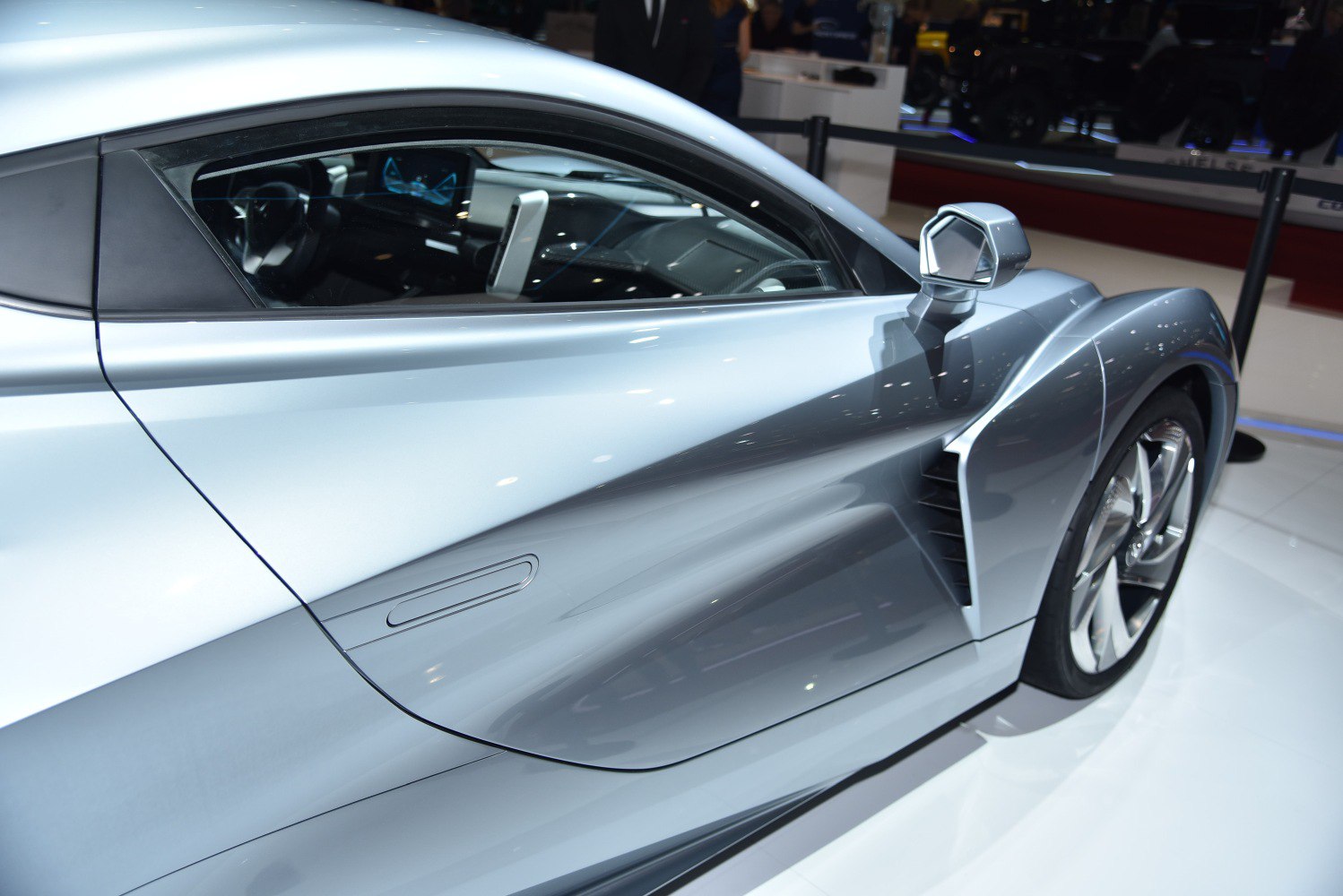Aerodynamic side vent and sleek door design with visible interior and wheel.