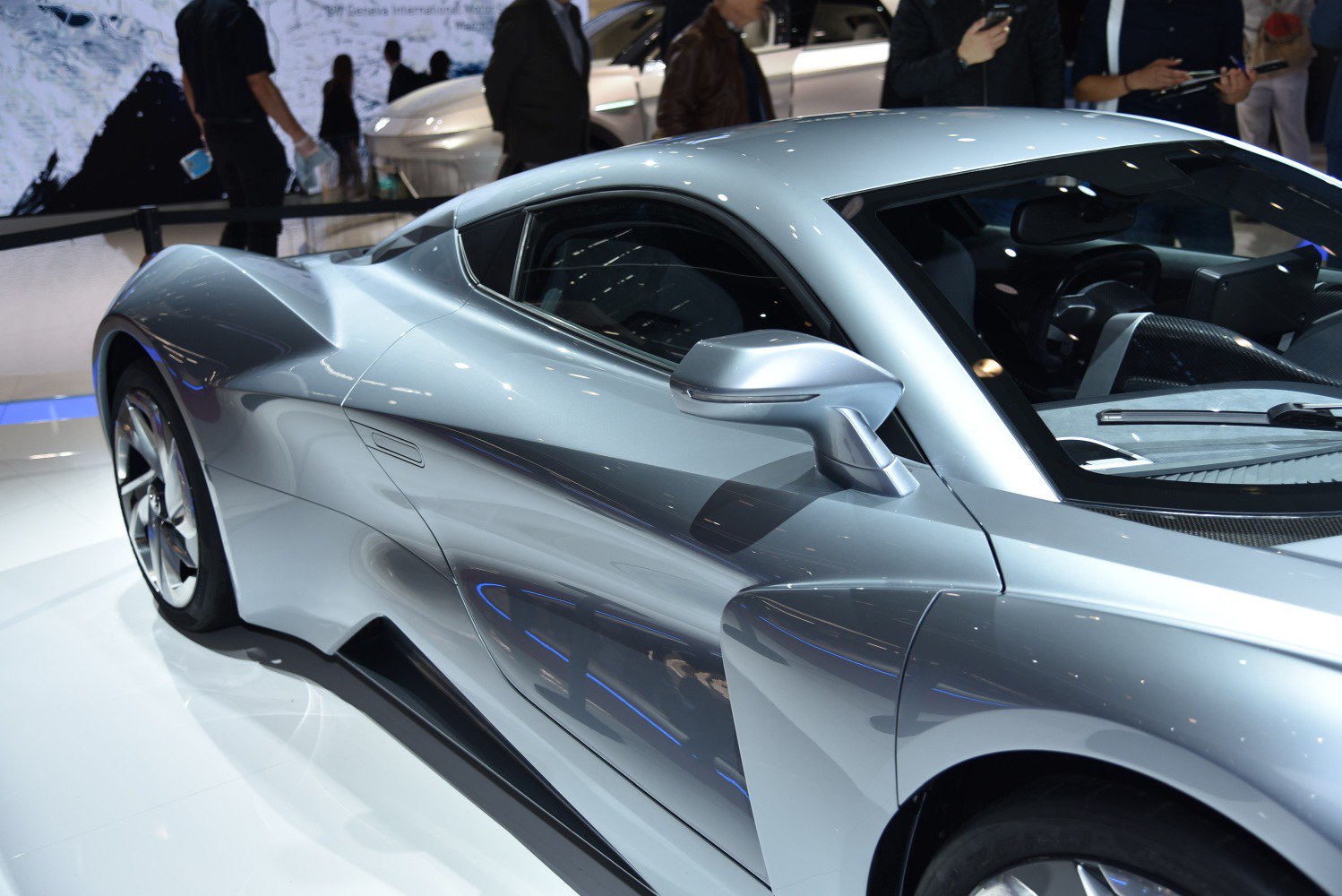Sleek silver sports coupe with aerodynamic side curves and modern mirror