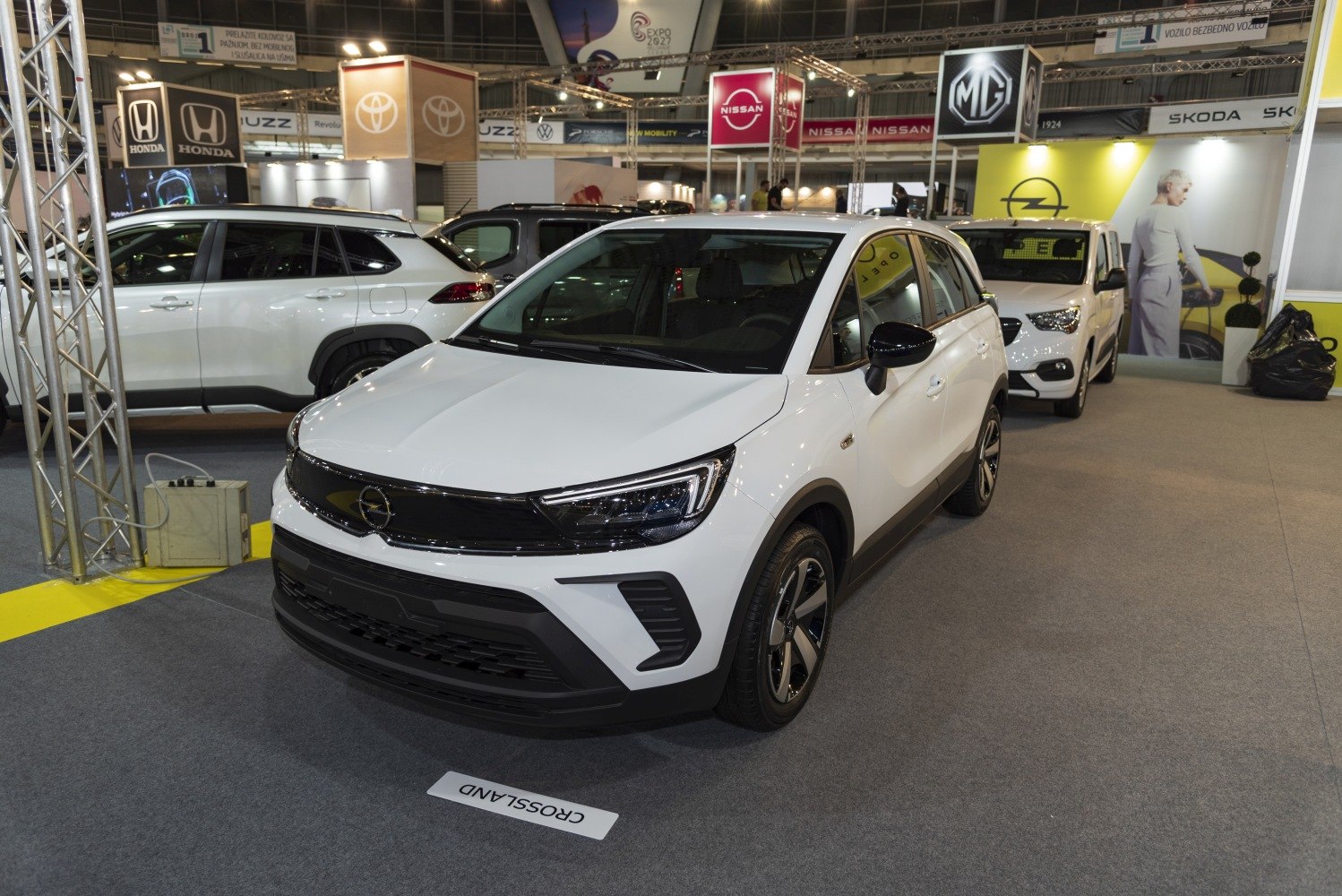Front view of a white compact SUV with sleek LED headlights and black grille