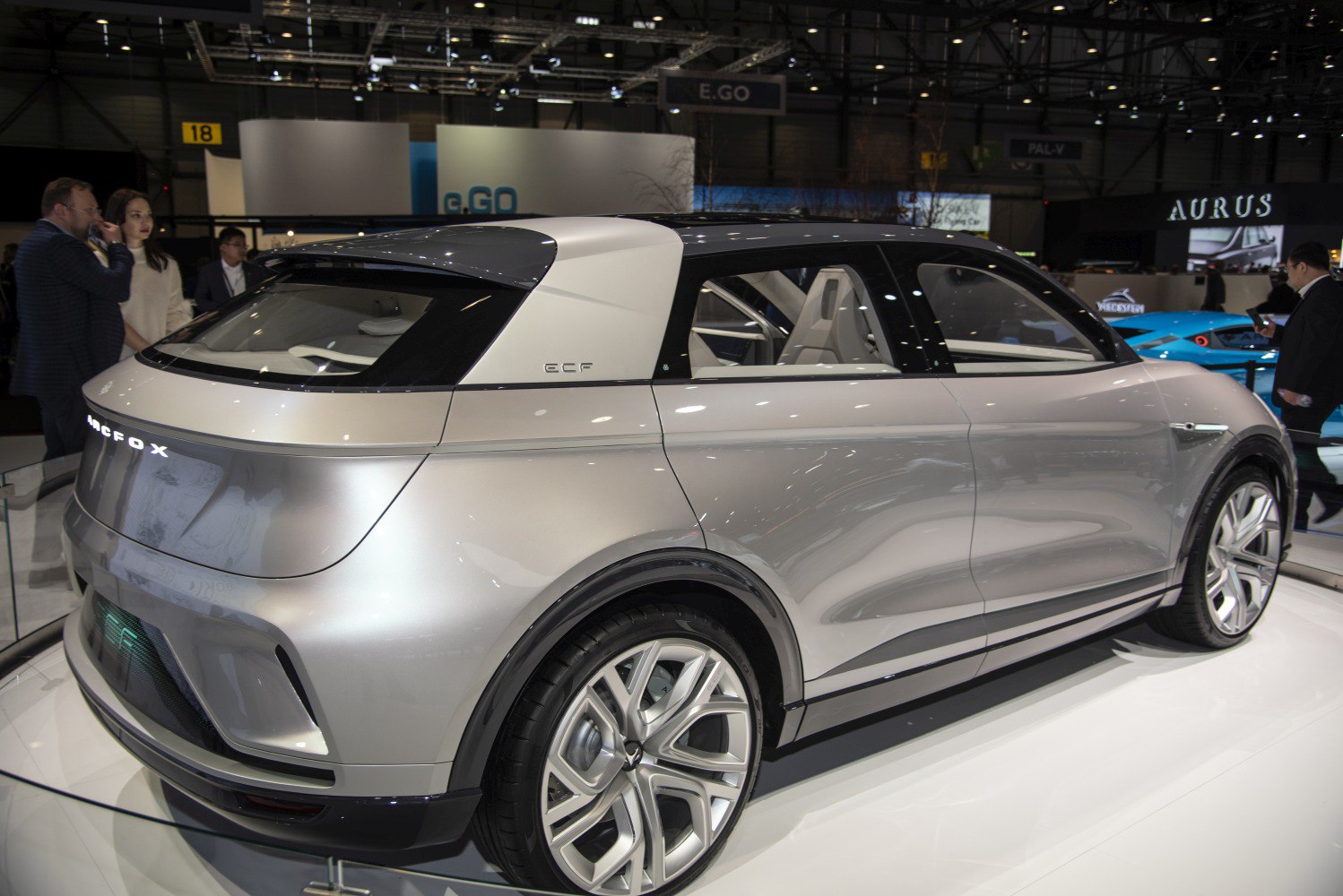 Silver futuristic electric SUV rear side with large alloy wheels