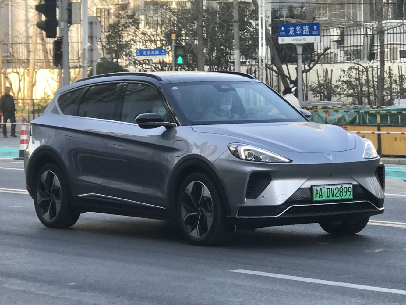 Front and side view of a sleek electric SUV with LED headlights.