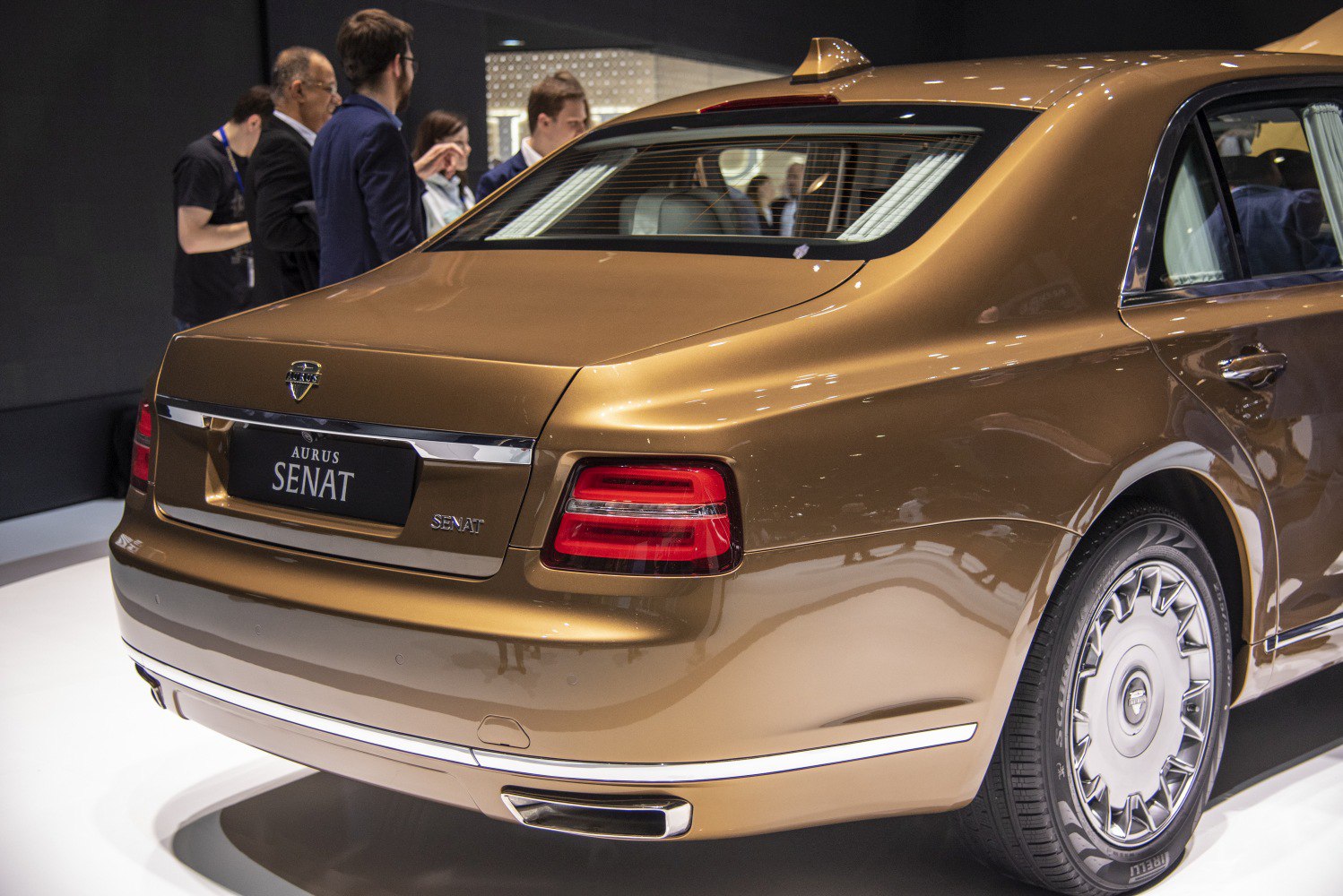 Luxury sedan rear design with distinctive tail lights and Pirelli tires