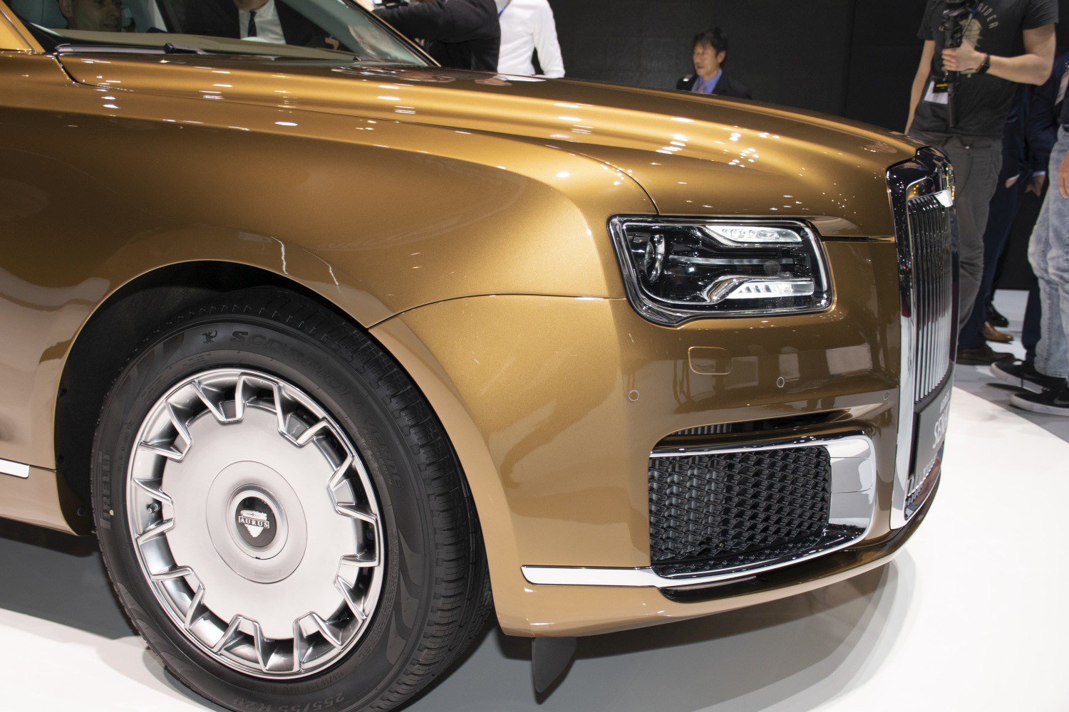 Close-up of luxury car front headlight and wheel design