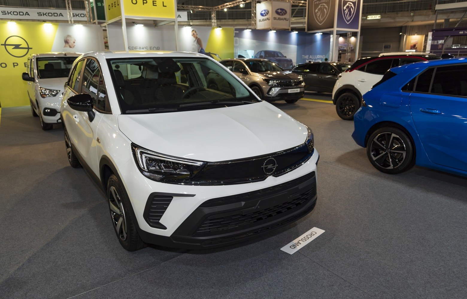 White SUV front view with LED headlights and glossy black grille