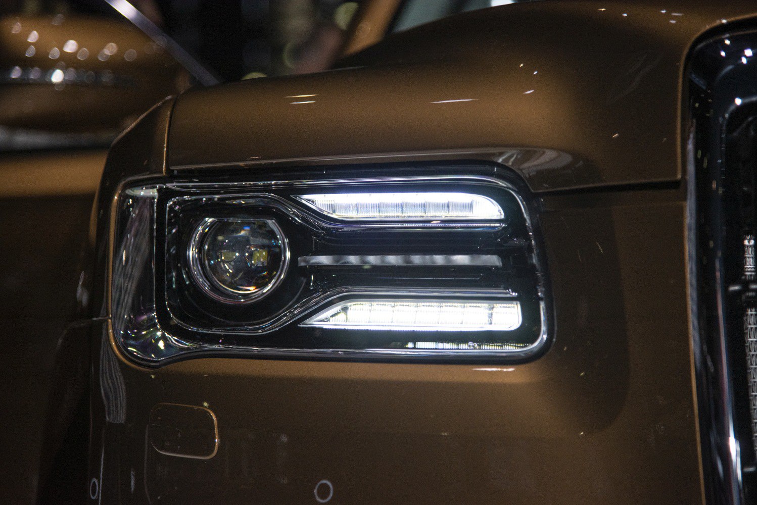 Close-up of a modern LED headlight with distinct layered lighting elements.