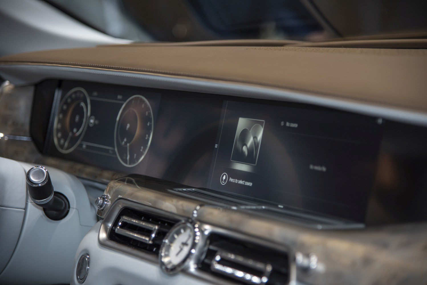 Digital instrument cluster combined with analog clock on luxury dashboard