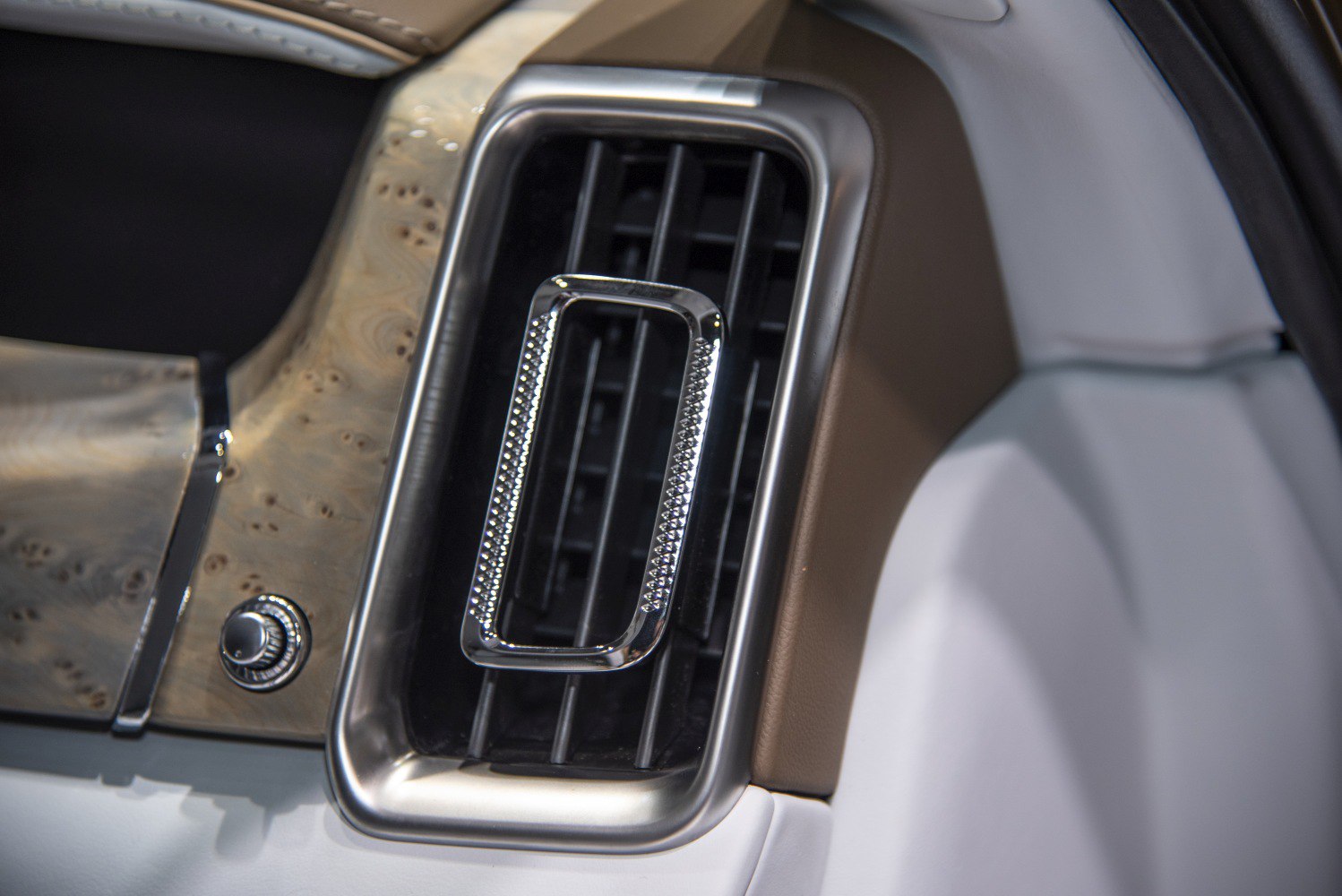 Luxury chrome-accented air vent in high-end car interior