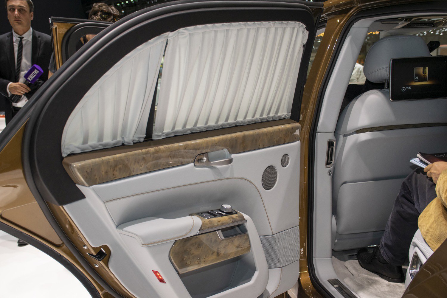 Luxury rear door interior with privacy curtain and wood trim